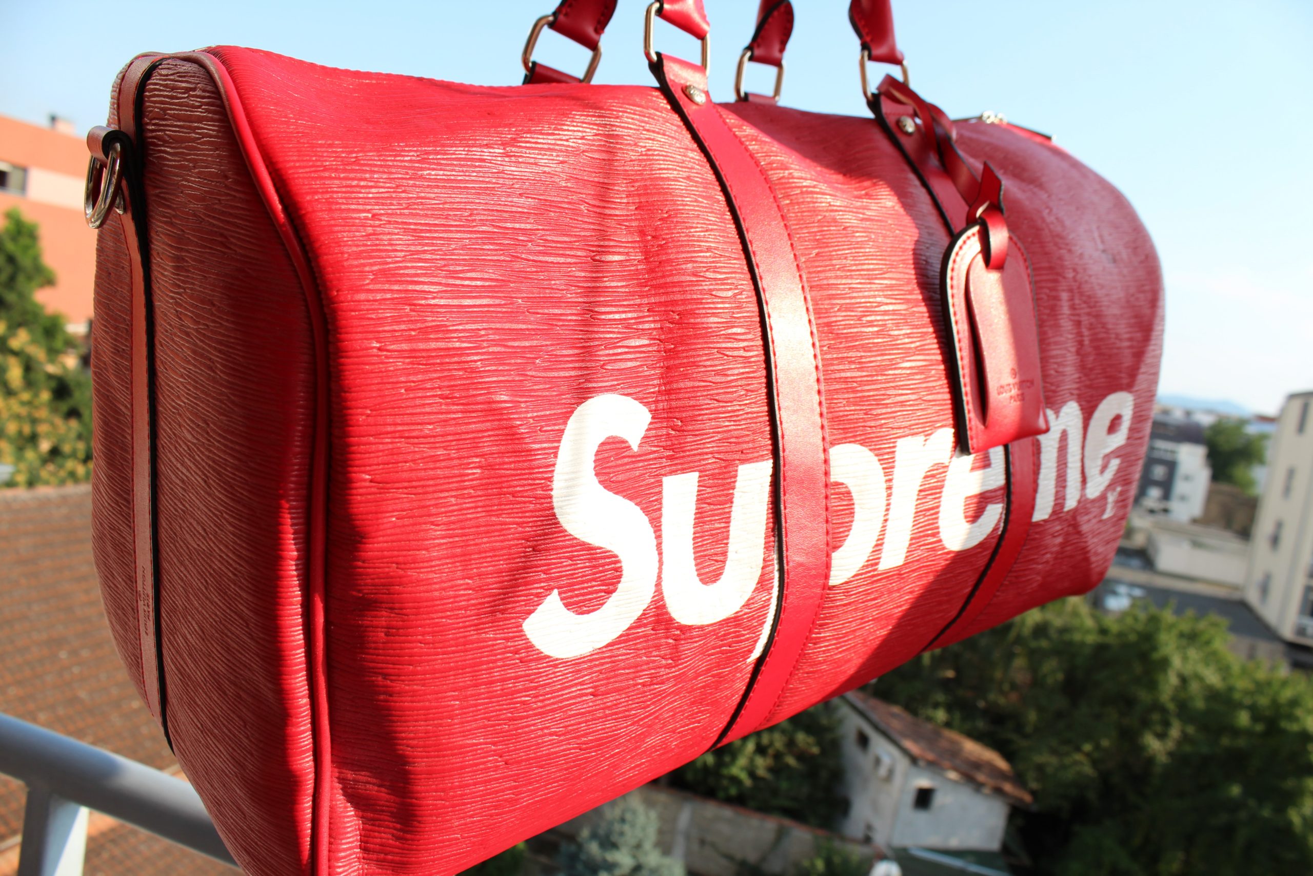 A duffle bag branded with the Supreme logo