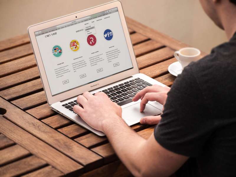a person optimizing the content of their website on their laptop