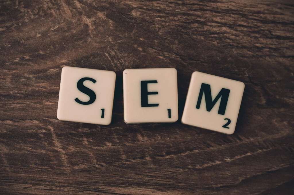scrabble tiles spelling "SEM" meaning search engine marketing