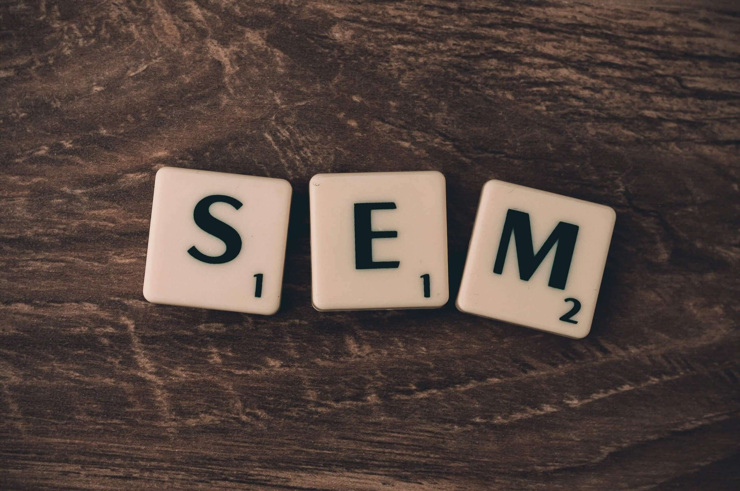 scrabble tiles spelling "SEM" meaning search engine marketing
