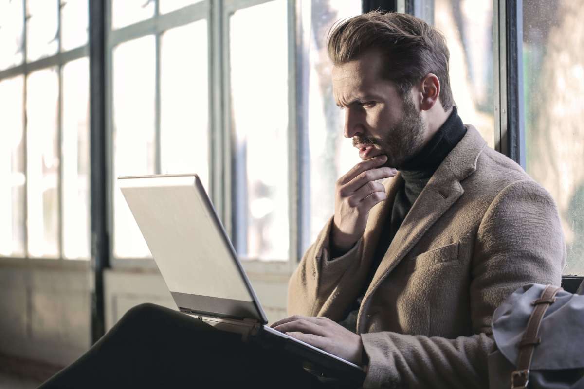 A confused person looking at their laptop
